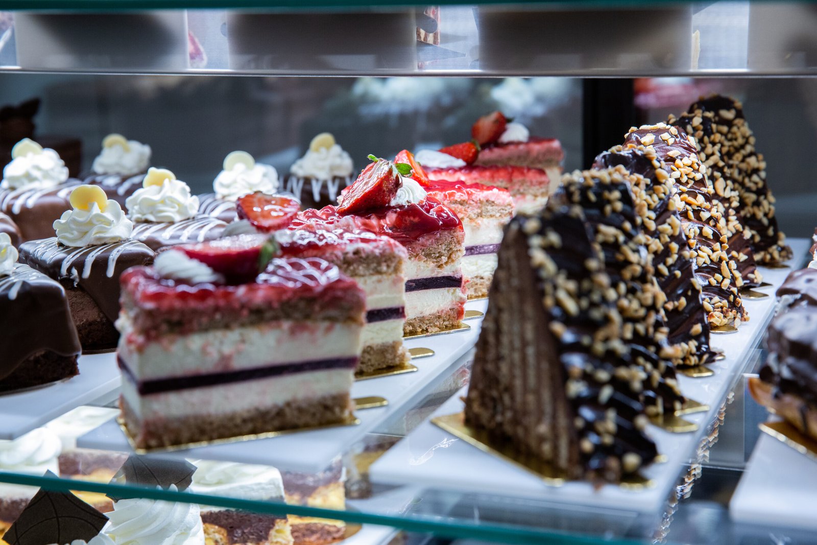 A view of various assortment of cakes on the stand in the bakery